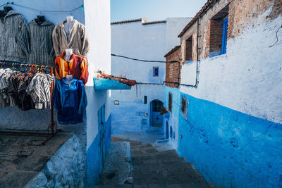 Clothes hanging on wall by steps