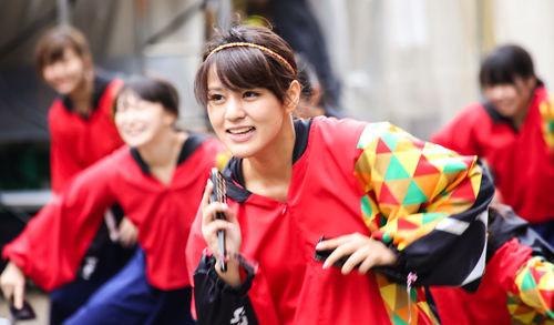 Portrait of smiling young woman standing outdoors