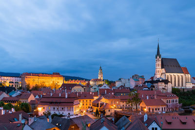 View of illuminated buildings against blue sky