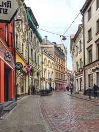 Road amidst buildings in city