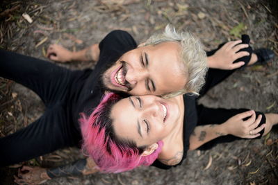 Smiling young couple sitting outdoors