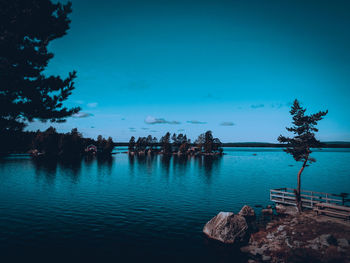 Scenic view of lake against blue sky at dusk