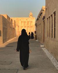 Rear view of woman walking on street