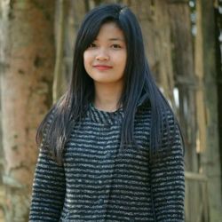 Portrait of smiling woman standing outdoors