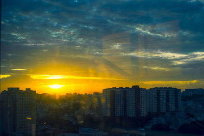 Buildings against sky during sunset