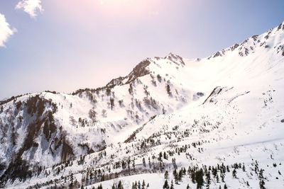 Scenic view of snow covered mountains against sky