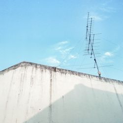 Low angle view of power lines against blue sky