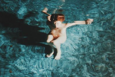 High angle view of woman swimming in pool