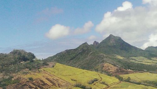 Scenic view of mountains against cloudy sky