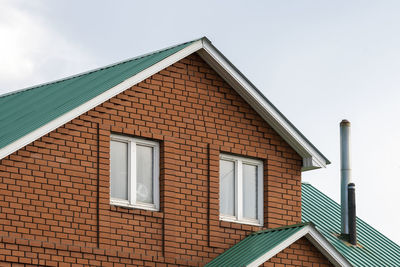 Red brick house with green roof. traditional european cultures architecture.