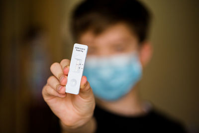 Close-up of boy holding rapid test corona