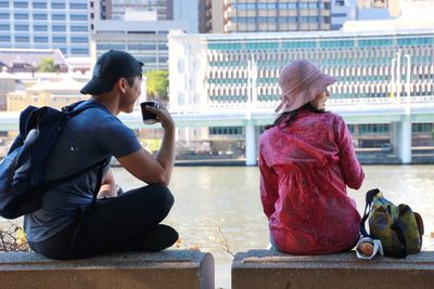 Full length of woman sitting in city