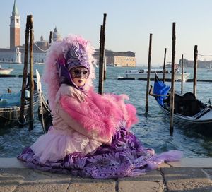 Portrait of woman with pink umbrella against sky