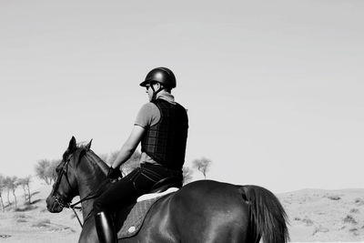 People riding horse against sky