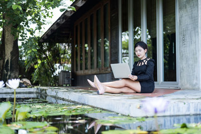 Beautiful businesswoman in black working on laptop . comfortable work or remote work concept.