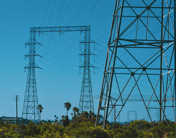 Low angle view of electricity pylon against sky