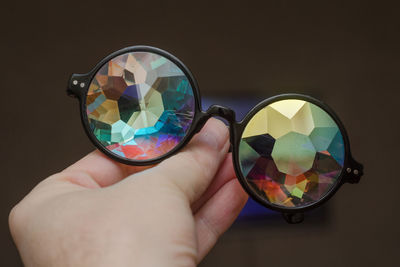 Close-up of hand holding glass with reflection