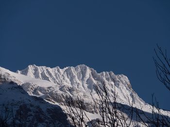 Low angle view of snow mountain against clear sky