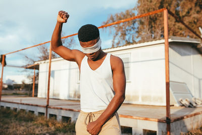 Full length of man standing by railing against sky