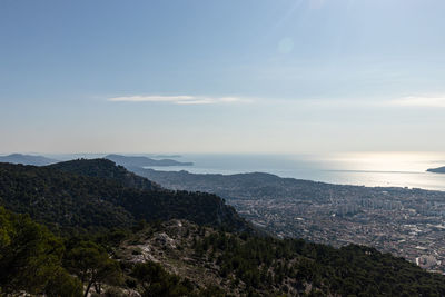 High angle view of city by sea against sky