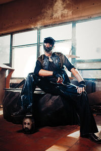 Man wearing costume while smoking cigar at home