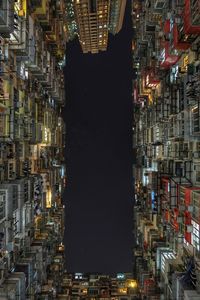 Directly below view of illuminated buildings in city at night