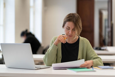 Middle-aged female working in campus study prepare for exam or serious test in university or college