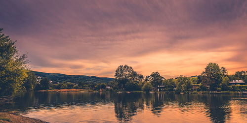 Scenic view of lake against romantic sky at sunset