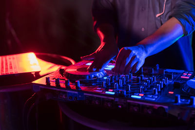 Midsection of man playing music concert at night