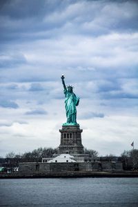 Statue of liberty against cloudy sky