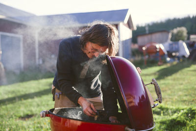 Woman having barbecue