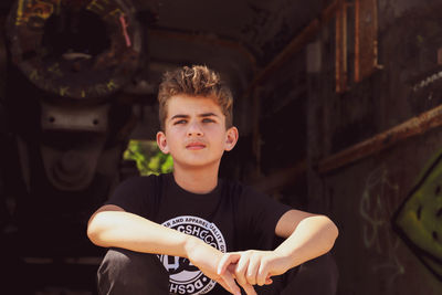 Portrait of boy sitting outdoors