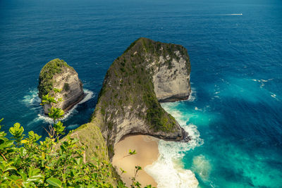 High angle view of rocks in sea against blue sky
