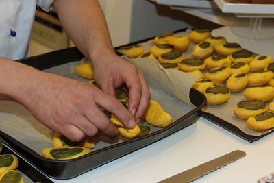 Midsection of man preparing food in kitchen