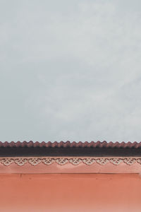 Low angle view of house roof against sky
