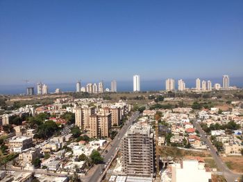 View of cityscape against blue sky