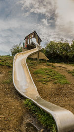 Slide at park against sky