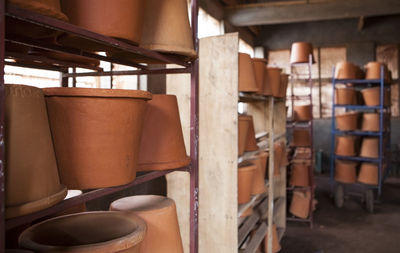 Clay pots on shelves at warehouse