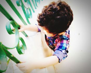 Boy standing against wall