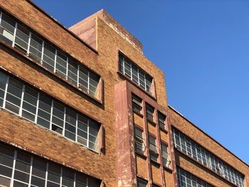 Low angle view of building against clear blue sky