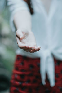 Low section of couple holding hands