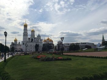 Garden by dormition cathedral against sky