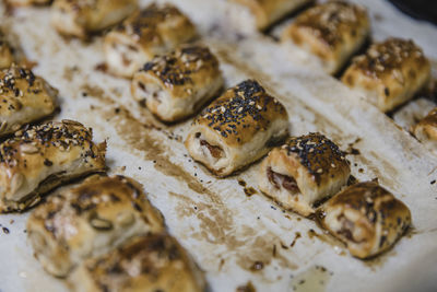 Small buns with sesame on parchment