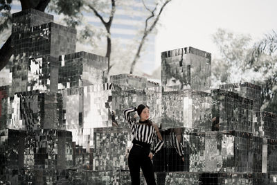 Full length of man standing against buildings in city