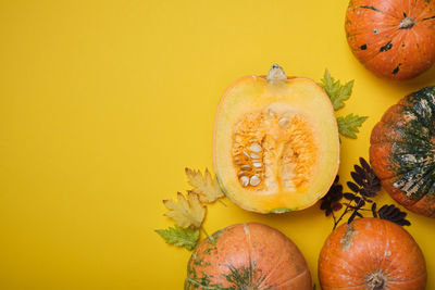 Close-up of pumpkins against orange background