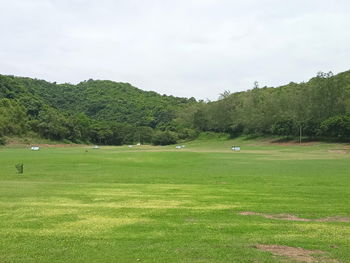 Scenic view of golf course against sky