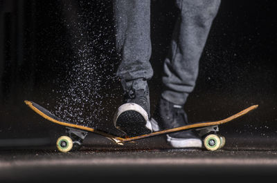 Low section of man standing on road