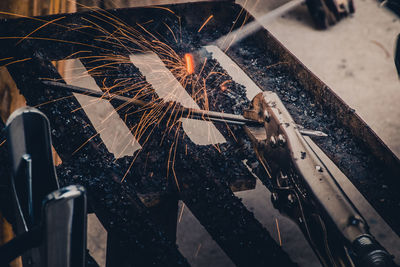 Low angle view of man working on metal