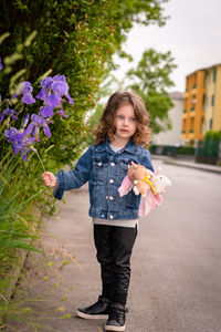 Cute girl touching flowers in park