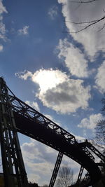 Low angle view of eiffel tower against cloudy sky